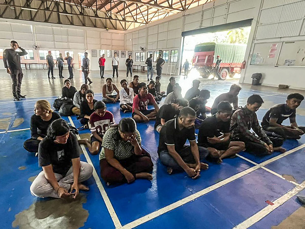 Survivors sitting after being rescued during a search and rescue operation off the coast of Pangkor Island in Perak.
