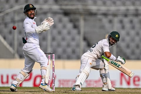 Pakistan's Mohammad Rizwan (R) watches the ball after playing a shot as Bangladesh's wicketkeeper Litton Das reacts during the fifth day of the first Test cricket match between Bangladesh and Pakistan at the Sher-e-Bangla National Stadium in Mirpur on May 12, 2026.