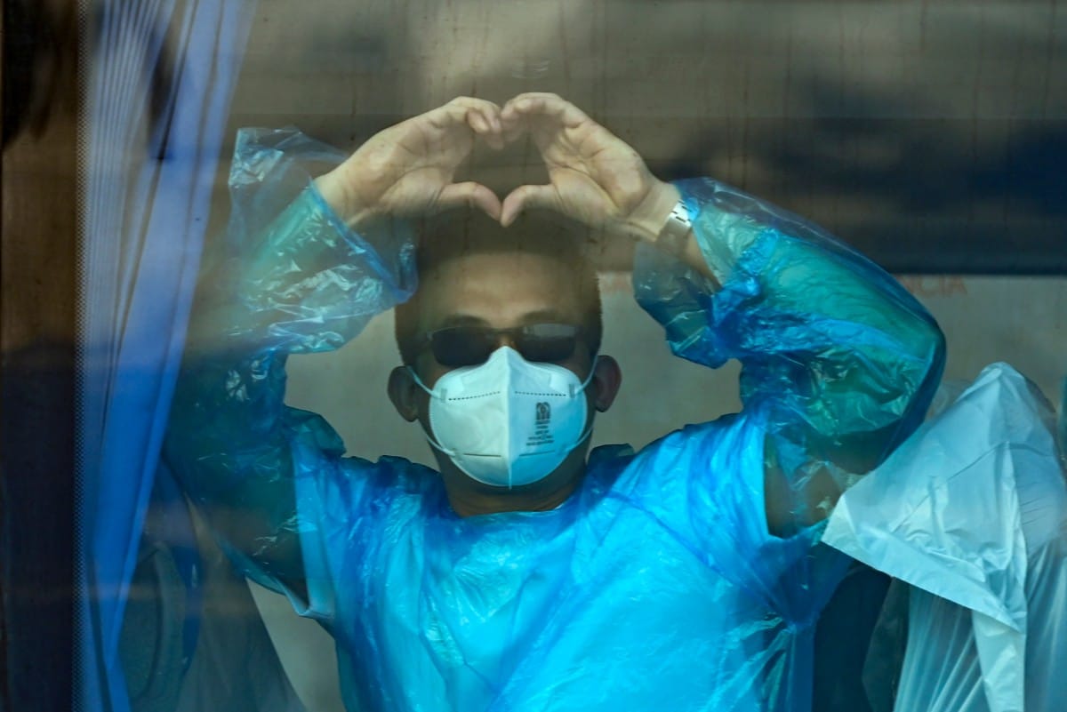 A passenger of the hantavirus-stricken cruise ship MV Hondius is pictured while leaving by military bus after disembarking in the port of Granadilla de Abona on the island of Tenerife in Spain's Canary Islands on May 11, 2026.