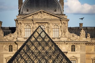 This photograph shows the top of the Louvre Pyramid, designed by Chinese-US architect Ieoh Ming Pei with the Louvre Museum in the background in Paris on May 9, 2026.