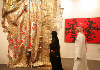 Visitors check out art displayed at Art Dubai in 2011, which has become a leading contemporary art fair for collectors artist and professionals from the Middle East,