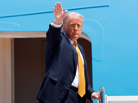 President Donald Trump waves from the stairs of Air Force One as he boards upon his arrival at Joint Base Andrews, Md.,, for a trip to China to meet President Xi Jinping.