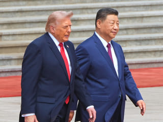 President Donald Trump walks with Chinese President Xi Jinping during a welcome ceremony at the Great Hall of the People, Thursday, May 14, 2026, in Beijing.