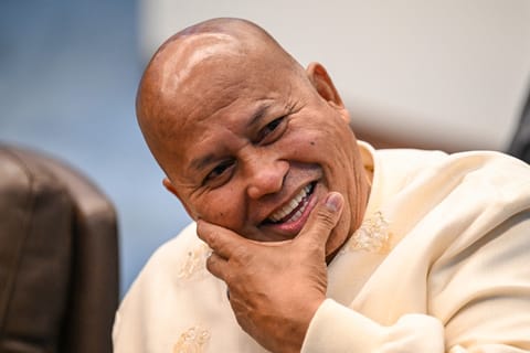 Philippine Senator Ronald Dela Rosa reacts as he talks to the media before the start of a plenary session at the Senate of the Philippines in Pasay, Metro Manila on May 12, 2026.