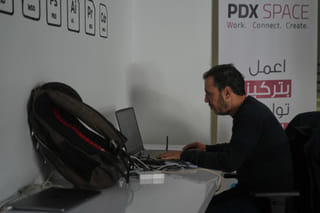 Palestinian programmer Tarik Zaeem, 44, works on his computer at a coworking space in Gaza City, March 8, 2026. (AP Photo/Abdel Kareem Hana)