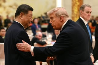 China's President Xi Jinping (L) looks at US President Donald Trump as they attend a state banquet at the Great Hall of the People in Beijing on May 14, 2026.