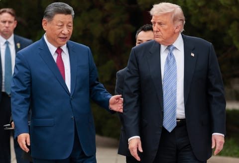 US President Donald Trump (R) walks with China’s President Xi Jinping (L) as he leaves after a visit to Zhongnanhai Garden in Beijing on May 15, 2026.