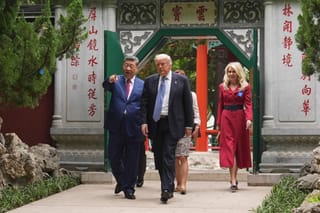US President Donald Trump (2nd R) walks with China’s President Xi Jinping (L) at the Zhongnanhai leadership compound in Beijing on May 15, 2026.
