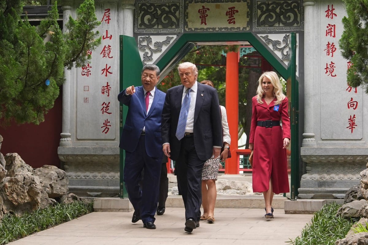 US President Donald Trump (2nd R) walks with China’s President Xi Jinping (L) at the Zhongnanhai leadership compound in Beijing on May 15, 2026.