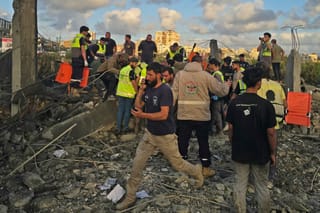 First responders gather at the site of an Israeli airstrike that targeted an area in the suburbs of the southern Lebanon coastal city of Tyre on May 16, 2026.
