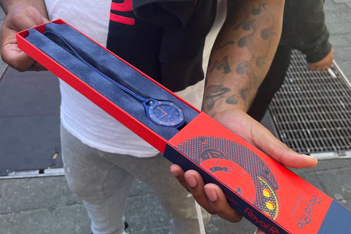 A customer shows his newly purchased Audemars Piguet x Swatch Royal Pop watch outside of a Swatch store in Times Square in New York on May 16, 2026.