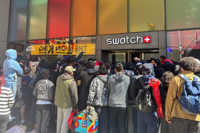 People wait in line to enter the Swatch store in Times Square in New York on May 16, 2026, ahead of the Audemars Piguet x Swatch Royal Pop watch release.