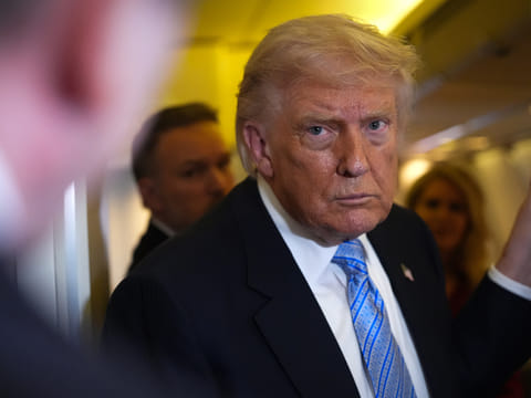 President Donald Trump speaks to reporters aboard Air Force One, Friday, May 15, 2026, as he returns from a trip to Beijing, China. 