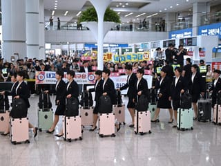 39 North Korean players and staff were greeted by supporters holding welcome signs upon arrival at the airport. 