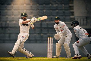 Pakistan’s Babar Azam (L) plays a shot as Bangladesh’s wicketkeeper Litton Das (C) and Mominul Haque field the ball during the second day of the second Test cricket match between Bangladesh and Pakistan at the Sylhet International Cricket Stadium