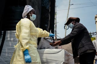 A visitor washes his hands before entering Kyeshero Hospital at a checkpoint for hand washing and temperature screening for all visitors and patients entering Kyeshero Hospital, as part of Ebola prevention measures in Goma on May 18, 2026.