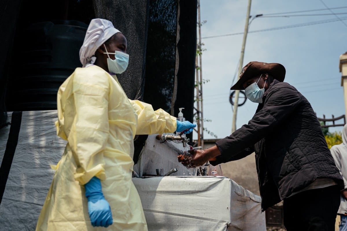 A visitor washes his hands before entering Kyeshero Hospital at a checkpoint for hand washing and temperature screening for all visitors and patients entering Kyeshero Hospital, as part of Ebola prevention measures in Goma on May 18, 2026.