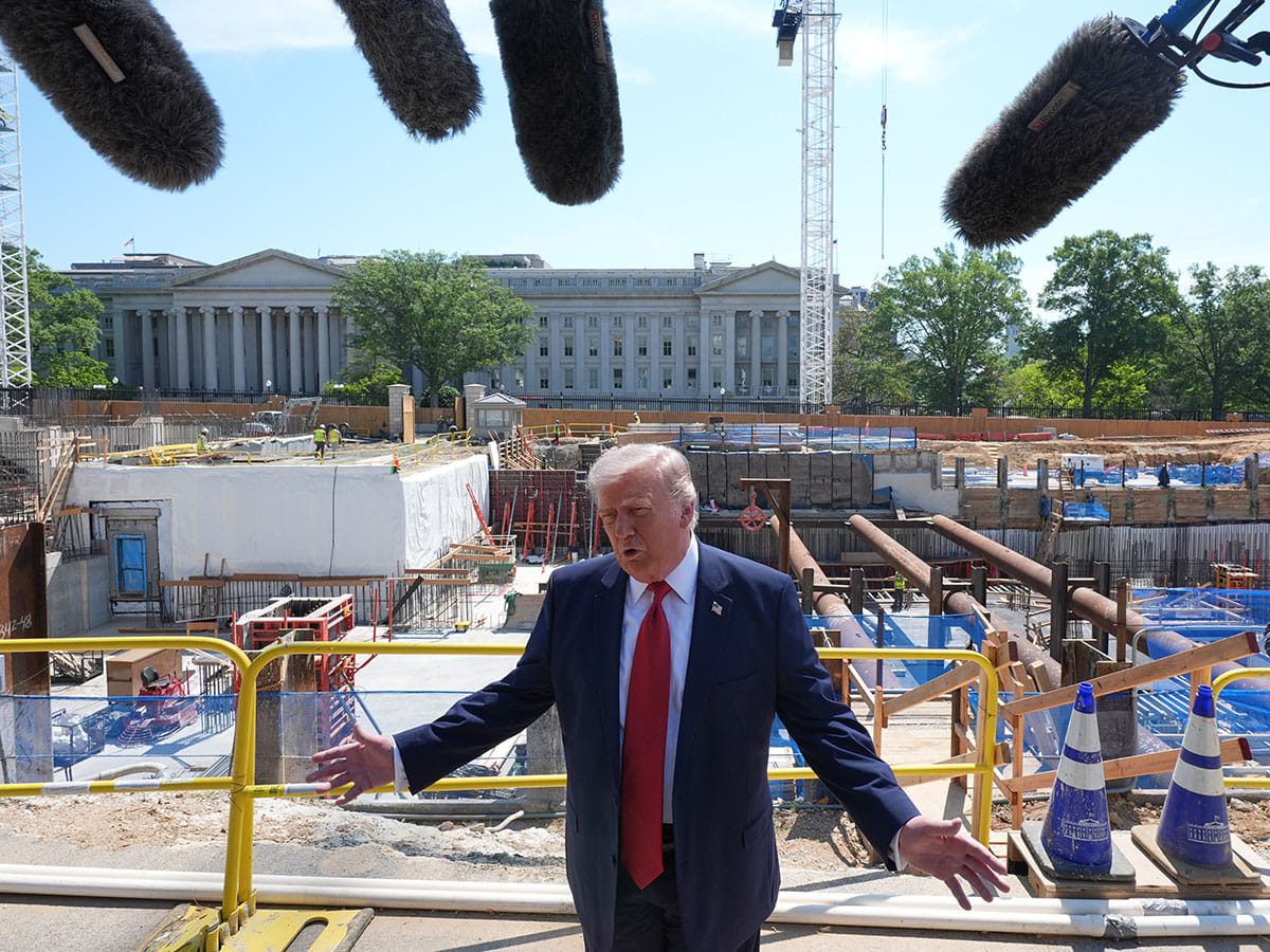 President Donald Trump speaks as he tours Ballroom construction around the outside the White House in Washington.