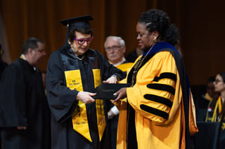 Tennis legend Billie Jean King, left, receives her diploma from California State University, Los Angeles, President Berenecea Johnson Eanes during commencement in Los Angeles, Monday, May 18, 2026. (AP Photo/Jae C. Hong)