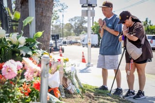 People pray at a makeshift memorial outside the Islamic Center of San Diego (ICSD) on May 19, 2026 in San Diego, California.