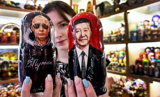 A vendor offers traditional Russian wooden nesting dolls, Matryoshka dolls, depicting Russian President Vladimir Putin and Chinese President Xi Jinping at a gift shop in downtown Moscow on May 19, 2026, as the Russian leader in on a visit to Beijing on May 19-20.