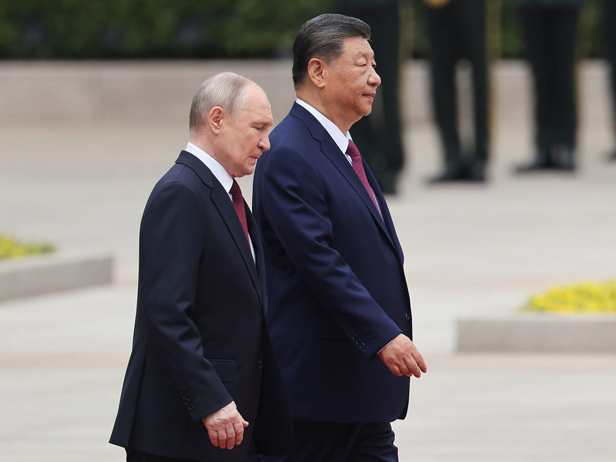Russian President Vladimir Putin, left, walks with Chinese President Xi Jinping during a welcoming ceremony at the Great Hall of the People in Beijing Wednesday, May 20, 2026.