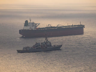 A tanker being tracked by a US Navy vessel. Iran's ISNA News Agency reported that US and Iran are engaged in indirect talks aimed at developing a framework as the two sides attempt to strike a deal.