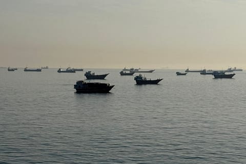 Vessels are seen anchored in the Strait of Hormuz, off the port city of Khasab on Oman’s northern Musandam Peninsula on May 17, 2026.