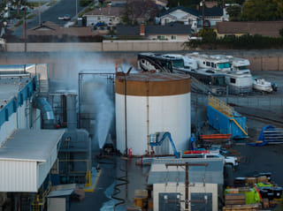 Water is sprayed on a tank that overheated at an aerospace plant in Garden Grove, Calif., Friday, May 22, 2026. (AP Photo/Ethan Swope)