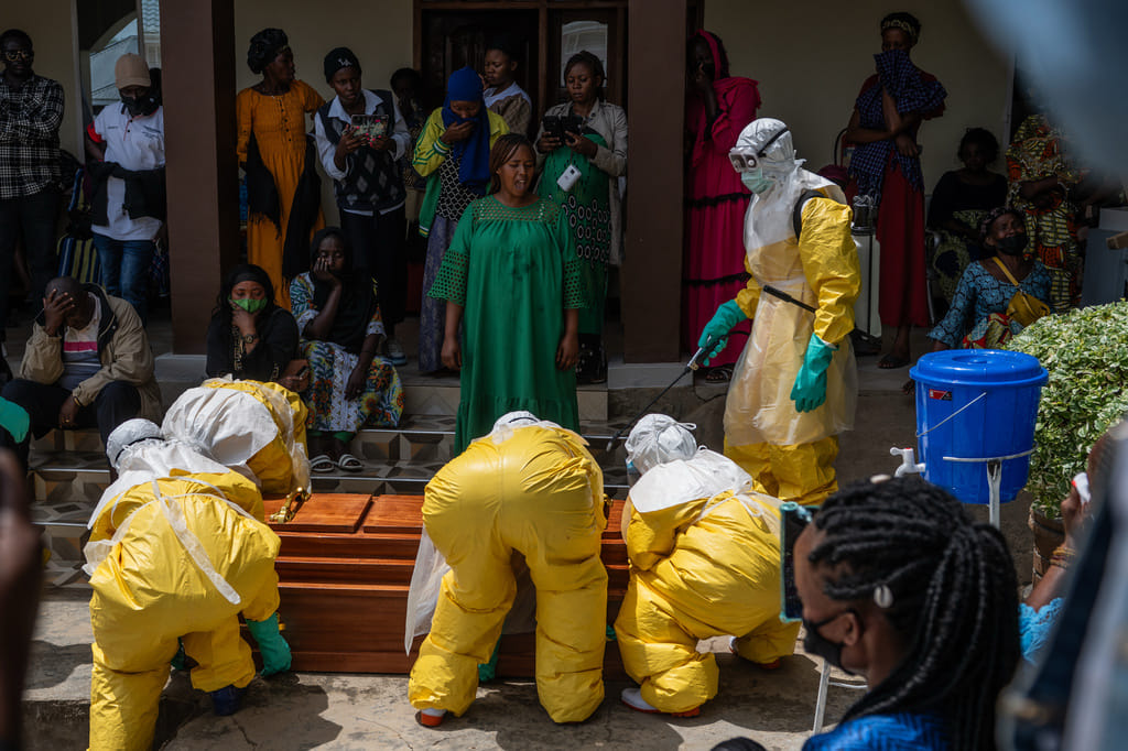 Family members of an Ebola victim mourn as the coffin is taken away for burial, at Sofepadi Hospital in Bunia, Congo, Saturday, May 23, 2026. (AP Photo/Moses Sawasawa)