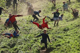 Thrill-seekers chase glory at UK cheese-rolling race
