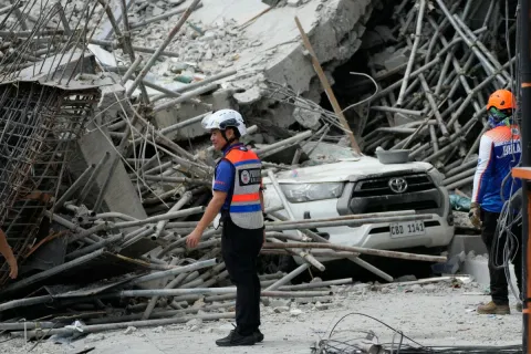 Rescuers stand beside ruins as search operations continue in a collapsed building in Angeles City in Pampanga, Monday, May 25, 2026.
