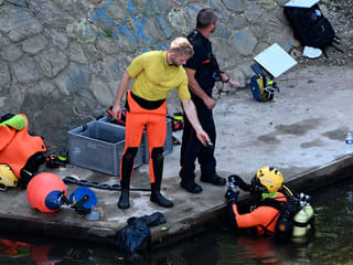 Divers search for evidences in the Vilaine river near the site where the body of a 11-year-old boy was found dead the day before in Rennes.
