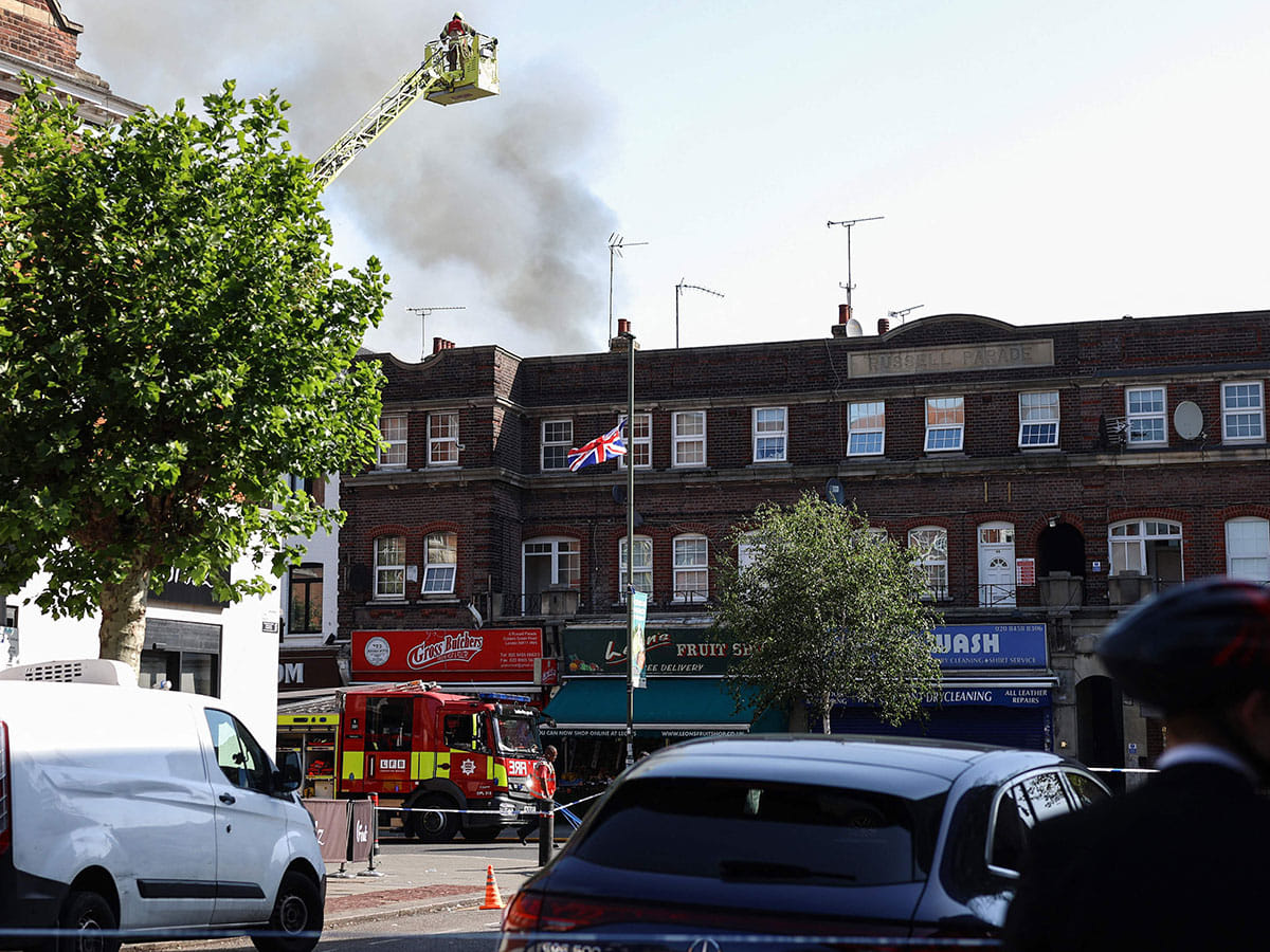 Emergency services work at the site of a fire which broke out at a supermarket in the Golders Green neighbourhood in north London.