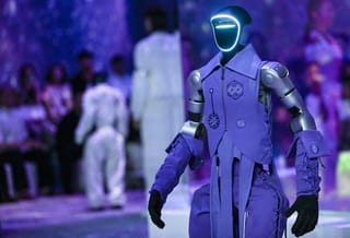 A humanoid robot presents creations at Galaxy Corporation's "Mach33: Physical AI Fashion Show" in Seoul.