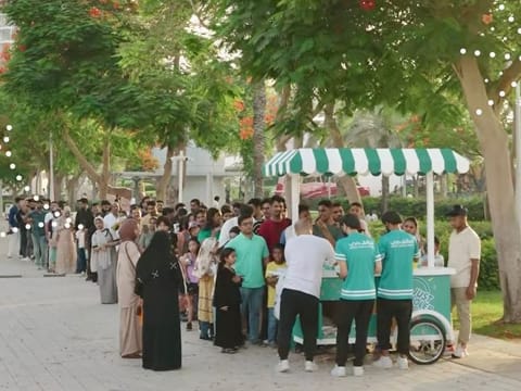 A screengrab of the video shows long queues of young and old park visitors waiting to receive their Eid treat. 