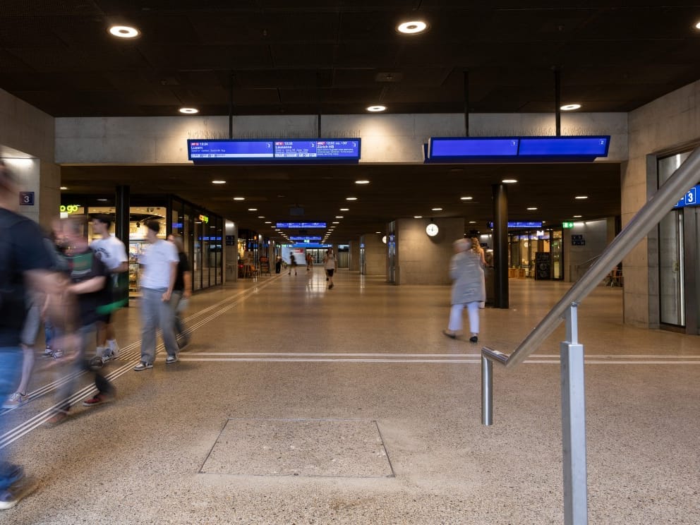 Commuters walk through an underground passageway at a train station where a man wounded three people with a bladed weapon in Winterthur, near Zurich on May 29, 2026.