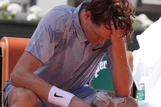 Jannik Sinner of Italy reacts as he cools himself with the water during a break at the second round men's singles tennis match against Juan Manuel Cerundolo of Argentina at the French Open tennis tournament in Paris, Thursday, May 28, 2026, as temperature rises up to 33 C (91 F). (AP Photo/Thibault Camus)