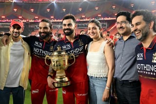 Royal Challengers Bengaluru's Indian cricket players captain Rajat Patidar (2L) and Virat Kohli (3L) alongside his wife and Bollywood actress Anushka Sharma (3R) celebrate after their team's win against Gujarat Titans at the end of the 2026 Indian Premier League (IPL) T20 final match in the Narendra Modi Stadium of Ahmedabad on June 1, 2026.