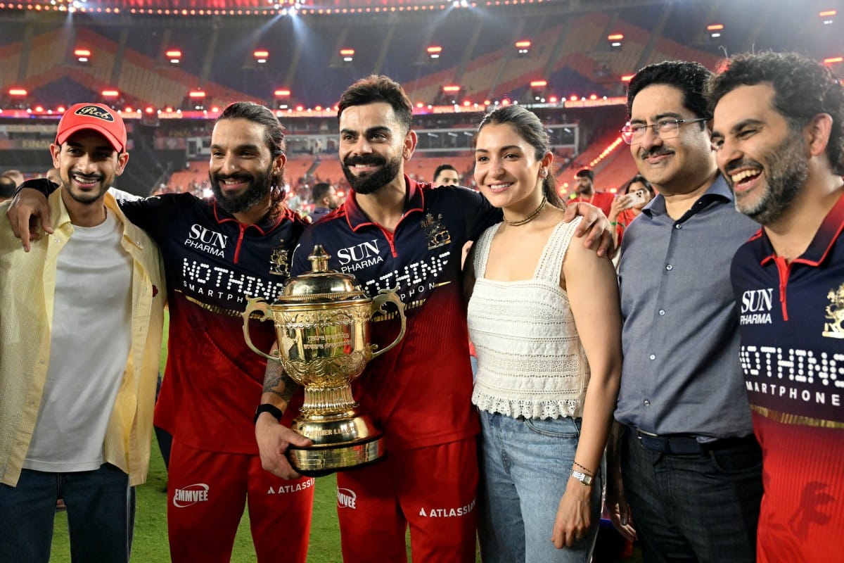 Royal Challengers Bengaluru's Indian cricket players captain Rajat Patidar (2L) and Virat Kohli (3L) alongside his wife and Bollywood actress Anushka Sharma (3R) celebrate after their team's win against Gujarat Titans at the end of the 2026 Indian Premier League (IPL) T20 final match in the Narendra Modi Stadium of Ahmedabad on June 1, 2026.