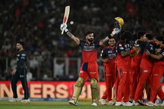 Royal Challengers Bengaluru's Indian cricket player Virat Kohli (C) celebrates with teammates after their team's win against Gujarat Titans at the end of the 2026 Indian Premier League (IPL) T20 final match in the Narendra Modi Stadium of Ahmedabad on May 31, 2026.