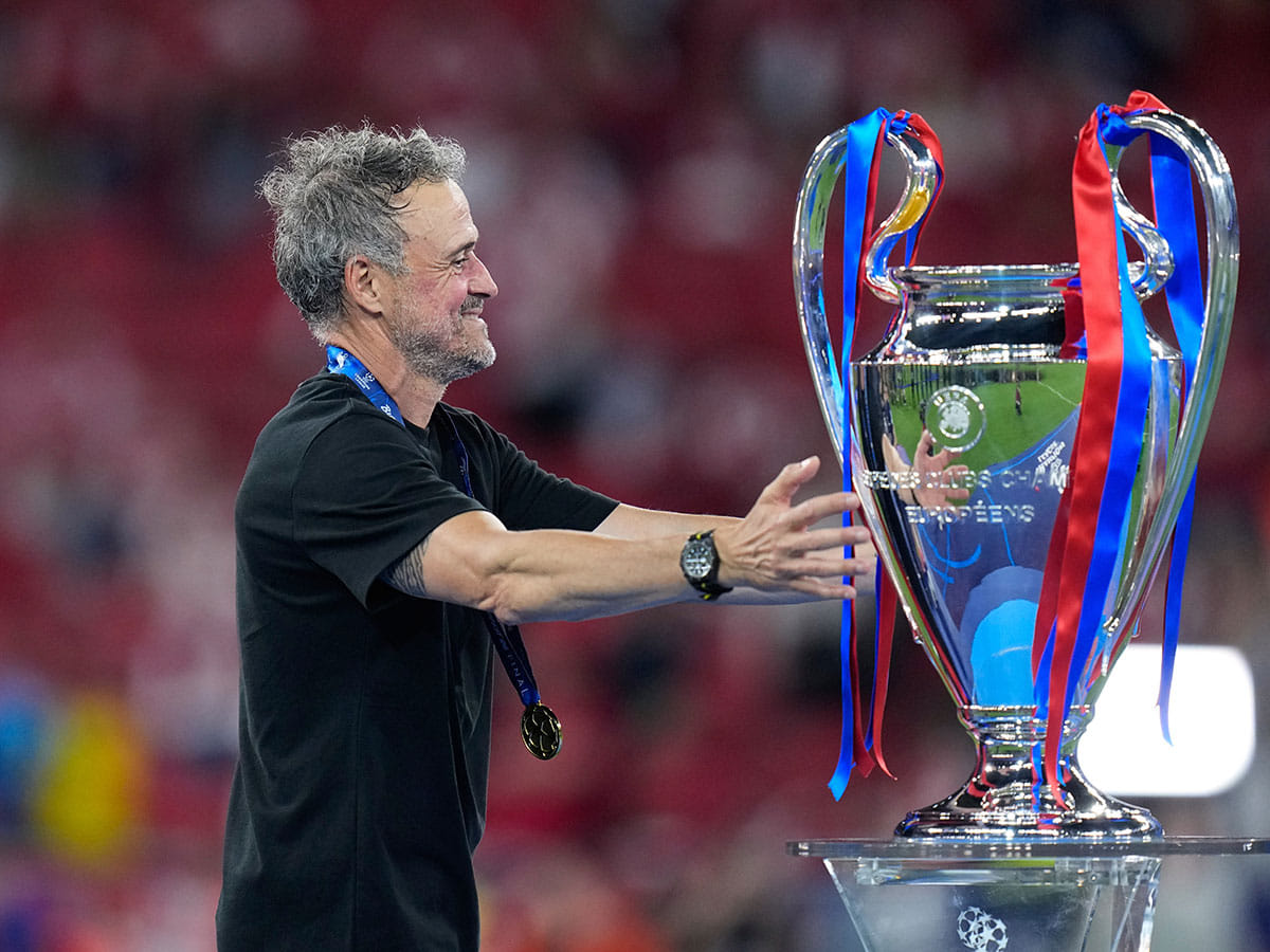 PSG's head coach Luis Enrique walks towards the trophy at the end of the Champions League final soccer match between Paris Saint-Germain and Arsenal in Budapest, Hungary.
