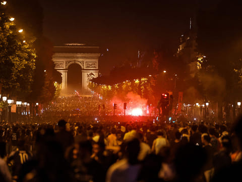 PSG supporters gather on the Champs-Elysees Avenue after the club won the UEFA Champions League final between Paris Saint-Germain (PSG) and Arsenal FC played in Budapest, in Paris.