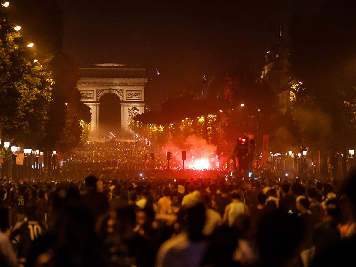 PSG supporters gather on the Champs-Elysees Avenue after the club won the UEFA Champions League final between Paris Saint-Germain (PSG) and Arsenal FC played in Budapest, in Paris.