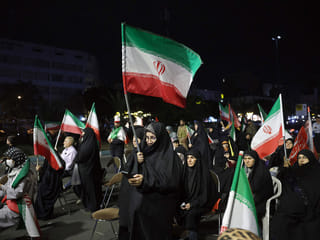 People hold Iran's national flags during an anti-US and Israel protest in Tehran