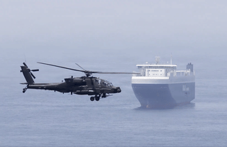 A US Apache attack helicopter flying over the Gulf. At the centre of the US-Iran dispute are two issues that negotiators have struggled to resolve for months: Iran’s stockpile of highly-enriched uranium and the future status of the Strait of Hormuz.