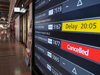 A departures board shows a cancelled flight to Okinawa after Severe Tropical Storm Jangmi shut down the airport there as it moved toward mainland Japan.