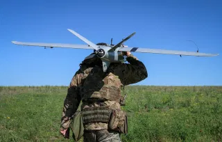 A Ukrainian soldier carries a drones. Cross-border drone attacks have intensified in recent months as Russia and Ukraine continue to trade strikes in the more than four-year war.