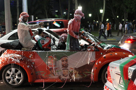 Emirati youth take to the roads of Abu Dhabi to celebrate UAE National Day with a decorated car displaying the portraits of the UAE's rulers and colours of the national flag. 