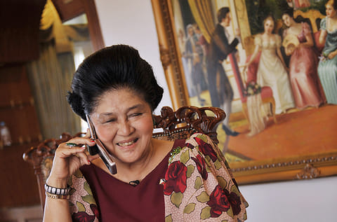 Philippine's former first lady Imelda Marcos speaks on a mobile phone 